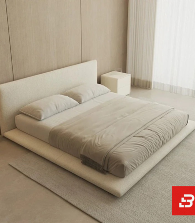 Minimalist low-profile upholstered platform bed in off-white bouclé fabric with extended base frame by Bahoo Furniture UAE