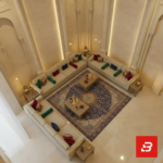 Overhead bird's-eye view of a luxury upholstered open majlis sectional sofa in beige velvet fabric surrounding a large ornate blue and gold Persian carpet by Bahoo Furniture UAE