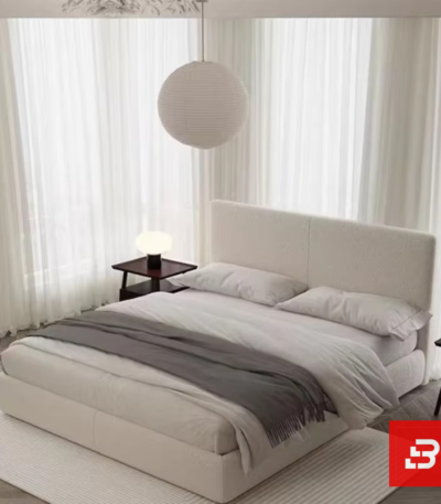 Minimalist paneled upholstered platform bed in soft cream bouclé fabric with clean vertical split headboard by Bahoo Furniture UAE