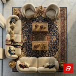 Curved modular velvet sofa and armchair set in warm beige fabric arranged around a traditional rug by Bahoo Furniture UAE