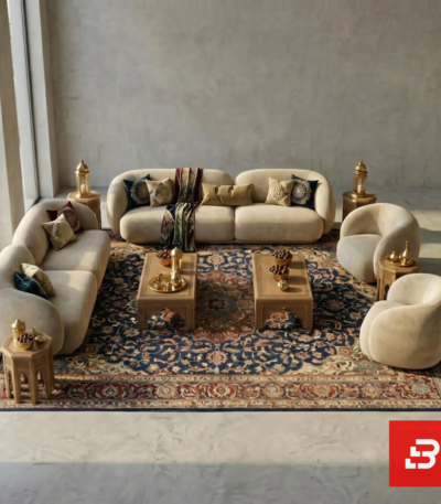 Curved modular velvet sofa and armchair set in warm beige fabric arranged around a traditional rug by Bahoo Furniture UAE