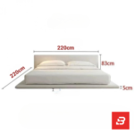 Minimalist low-profile upholstered platform bed in off-white bouclé fabric with extended base frame by Bahoo Furniture UAE