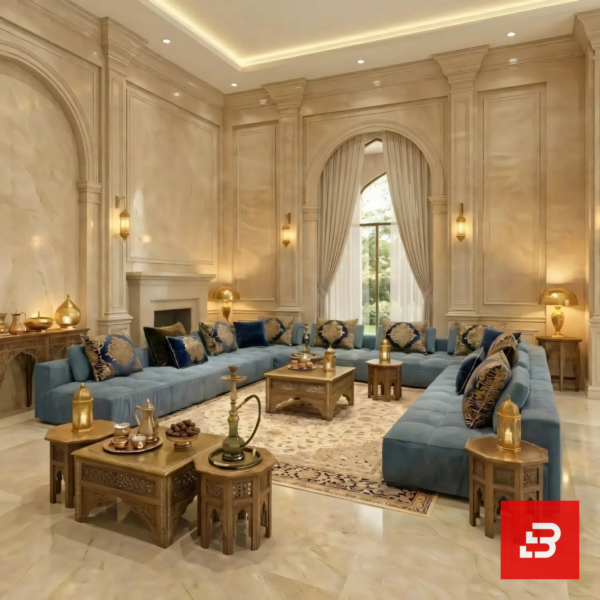 Interior view of a luxury upholstered royal arabic majlis sectional sofa in warm gray velvet fabric featuring intricate gold and blue cushions and carved wooden coffee tables by Bahoo Furniture UAE