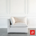 Studio interior view of a luxury upholstered modular corner lounge chair in off white velvet fabric featuring a plush back cushion and side armrest against a white wall paneling background by Bahoo Furniture UAE