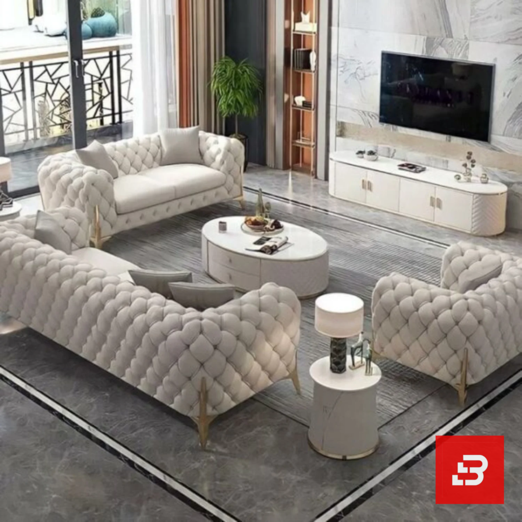 Overhead interior view of a luxury upholstered chesterfield living room set in off white velvet fabric featuring deep button tufting, gold legs, and a matching coffee table set by Bahoo Furniture UAE