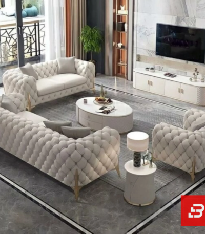 Overhead interior view of a luxury upholstered chesterfield living room set in off white velvet fabric featuring deep button tufting, gold legs, and a matching coffee table set by Bahoo Furniture UAE