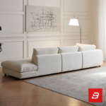 Modern bright living room interior view of a luxury modern sectional sofa upholstered in textured off white bouclé fabric featuring a plush chaise lounge and scatter cushions by Bahoo Furniture UAE