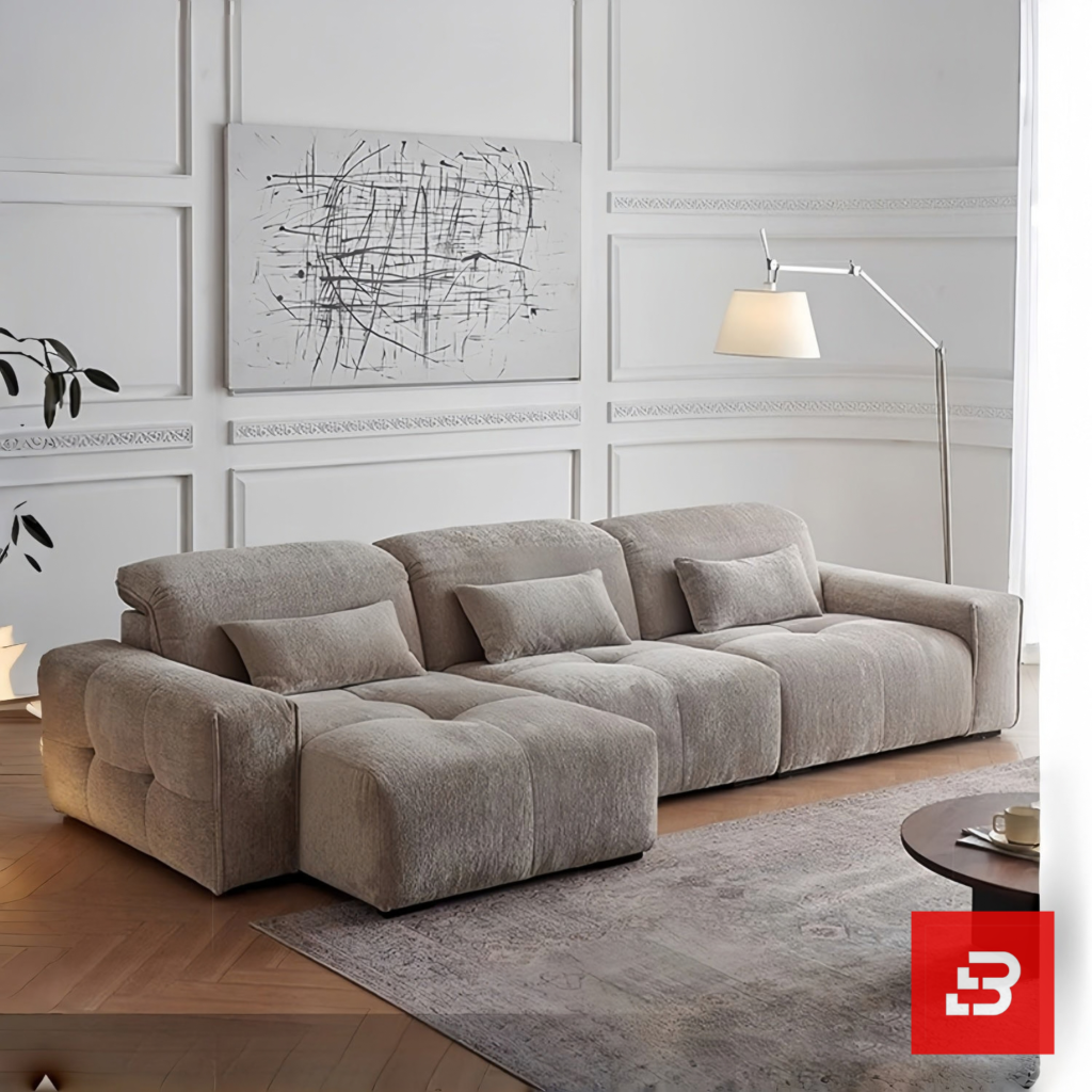 Modern living room interior view of a luxury tufted modular sofa upholstered in textured warm gray bouclé fabric featuring tufted seat cushions and lumbar pillows by Bahoo Furniture UAE