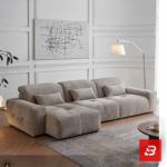 Modern living room interior view of a luxury tufted modular sofa upholstered in textured warm gray bouclé fabric featuring tufted seat cushions and lumbar pillows by Bahoo Furniture UAE