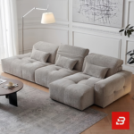 Modern living room interior view of a luxury tufted modular sofa upholstered in textured warm gray bouclé fabric featuring tufted seat cushions and lumbar pillows by Bahoo Furniture UAE