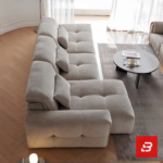 Modern living room interior view of a luxury tufted modular sofa upholstered in textured warm gray bouclé fabric featuring tufted seat cushions and lumbar pillows by Bahoo Furniture UAE