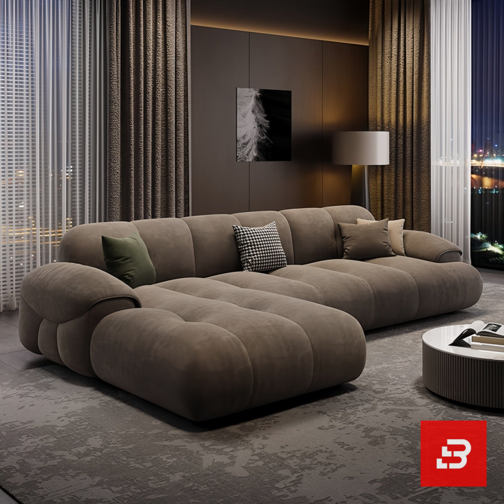 Evening luxury living room interior view of a luxury channel-tufted sectional sofa upholstered in plush warm gray velvet fabric featuring a chaise extension and accent cushions by Bahoo Furniture UAE
