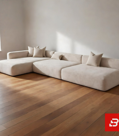 Sunlit minimal modern minimalist villa living room interior view of a luxury low-profile sectional upholstered in plush beige velvet fabric featuring an extended chaise lounge and comfortable scatter cushions by Bahoo Furniture UAE