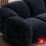 Bright modern minimalist living room interior view of a luxury channel tufted sofa upholstered in textured warm gray bouclé fabric featuring rounded fluted cushions and low-profile armrests by Bahoo Furniture UAE