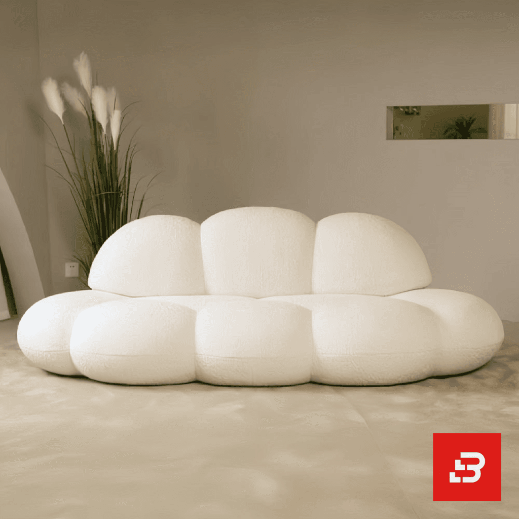 Minimalist modern interior view of a luxury cloud bubble sofa upholstered in textured off white bouclé fabric featuring rounded organic modular lobes and a low-profile silhouette by Bahoo Furniture UAE
