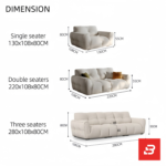 Sunlit warm modern living room interior view of a luxury channel-padded sofa upholstered in textured off white bouclé fabric featuring plush segmented cushioning and stylish contrast scatter cushions by Bahoo Furniture UAE