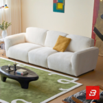 Bright minimalist modern living room interior view of a luxury contemporary modular sofa upholstered in textured off white bouclé fabric featuring clean streamlined armrests and low-profile cushions by Bahoo Furniture UAE