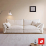 Bright minimalist modern living room interior view of a luxury low-slung sofa upholstered in textured off white bouclé fabric featuring extra deep plush cushions and relaxed angled armrests by Bahoo Furniture UAE