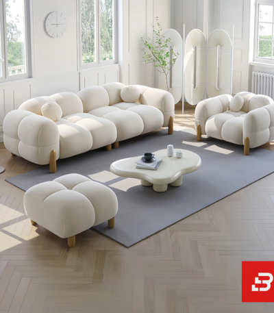 Bright modern sunlit living room interior showcasing a luxury bubble sofa set upholstered in textured off white bouclé fabric featuring rounded organic modules and wooden legs by Bahoo Furniture UAE