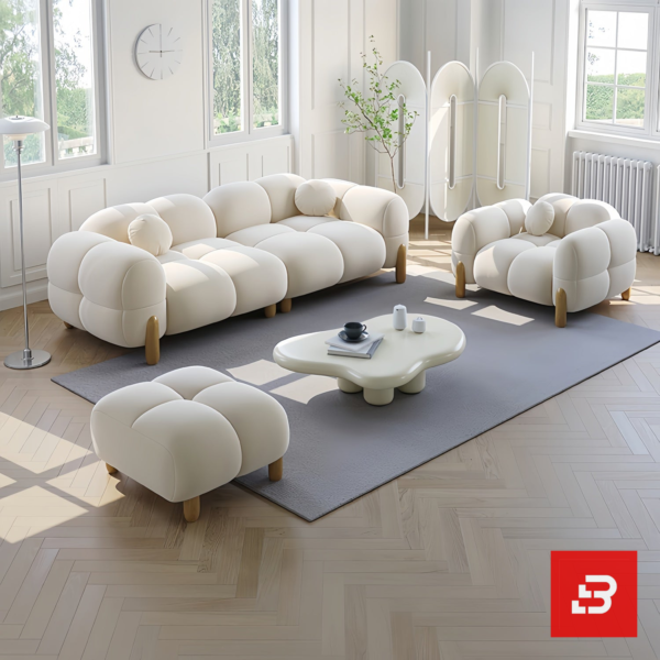 Bright modern sunlit living room interior showcasing a luxury bubble sofa set upholstered in textured off white bouclé fabric featuring rounded organic modules and wooden legs by Bahoo Furniture UAE