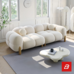 Bright modern sunlit living room interior showcasing a luxury bubble sofa set upholstered in textured off white bouclé fabric featuring rounded organic modules and wooden legs by Bahoo Furniture UAE