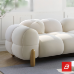 Bright modern sunlit living room interior showcasing a luxury bubble sofa set upholstered in textured off white bouclé fabric featuring rounded organic modules and wooden legs by Bahoo Furniture UAE