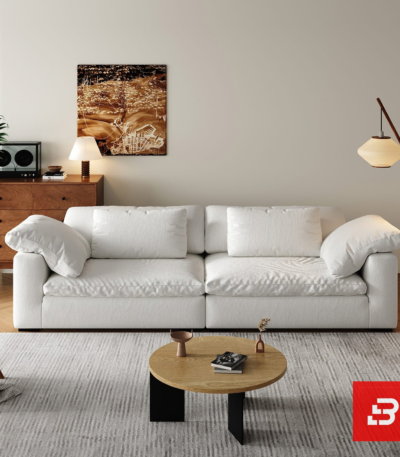 Bright warm modern living room interior showcasing a luxury cloud sofa upholstered in textured off white bouclé fabric with ultra-plush feather down-blend cushions and angled bolster pillows by Bahoo Furniture UAE