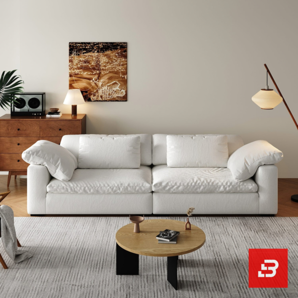 Bright warm modern living room interior showcasing a luxury cloud sofa upholstered in textured off white bouclé fabric with ultra-plush feather down-blend cushions and angled bolster pillows by Bahoo Furniture UAE