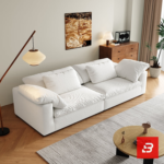 Bright warm modern living room interior showcasing a luxury cloud sofa upholstered in textured off white bouclé fabric with ultra-plush feather down-blend cushions and angled bolster pillows by Bahoo Furniture UAE