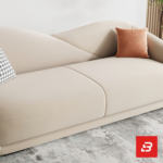 Bright modern sunlit living room interior showcasing a luxury curved sofa upholstered in smooth beige velvet fabric featuring a sweeping architectural backrest and stylish scatter cushions by Bahoo Furniture UAE