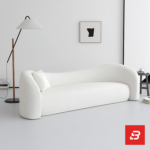 Bright minimalist modern living room interior showcasing a luxury wave sofa upholstered in textured off white bouclé fabric featuring a flowing organic silhouette and matching accent chairs by Bahoo Furniture UAE