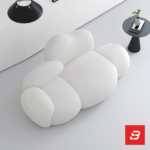 Bright minimalist modern living room interior showcasing a luxury cloud lounge chair upholstered in textured off white bouclé fabric featuring organic bulbous modules and a sleek arched floor lamp by Bahoo Furniture UAE