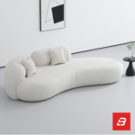 Bright minimalist modern living room interior showcasing an asymmetric chaise sofa upholstered in textured off white bouclé fabric featuring fluid organic curves and matching scatter cushions by Bahoo Furniture UAE