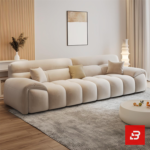 Bright elegant modern living room interior showcasing a luxury modular channel sofa upholstered in textured beige bouclé fabric featuring vertical channel tufting and stylish accent pillows by Bahoo Furniture UAE