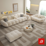 Bright warm modern living room interior showcasing a luxury cloud sectional sofa upholstered in textured off white bouclé fabric featuring pillowy channel modules and chic houndstooth accent pillows by Bahoo Furniture UAE