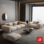 Evening luxury living room interior view of a luxury channel-tufted sectional sofa upholstered in plush warm gray velvet fabric featuring a chaise extension and accent cushions by Bahoo Furniture UAE