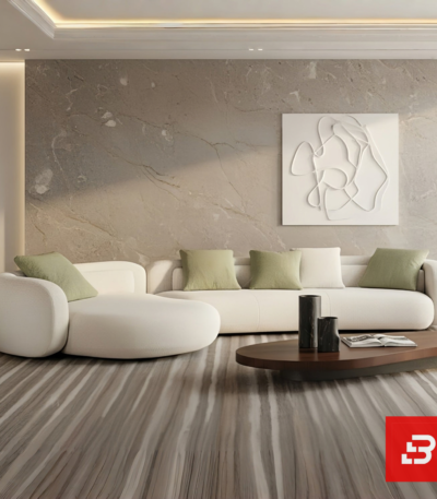 Modern minimalist living room interior view of a luxury curved chaise sofa upholstered in textured off white bouclé fabric featuring an extended lounge chaise and green accent pillows by Bahoo Furniture UAE