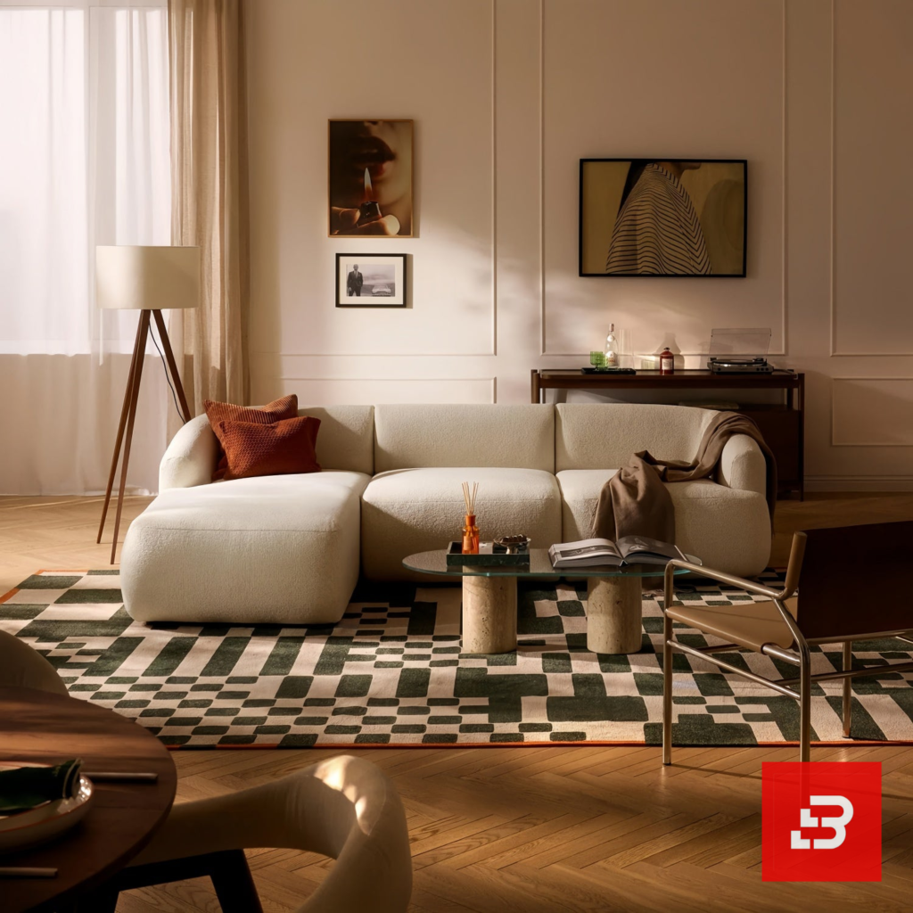 Warm modern apartment living room interior view of a luxury l-shaped sectional sofa upholstered in textured off white bouclé fabric featuring an extended chaise lounge and rust accent pillows by Bahoo Furniture UAE