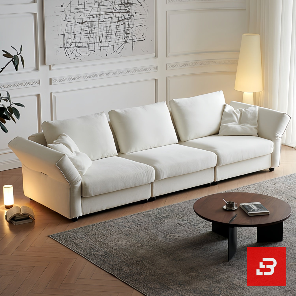 Warm elegant living room interior view of a luxury plump cushion sofa upholstered in textured off white bouclé fabric featuring deep plush back pillows and angled armrests by Bahoo Furniture UAE