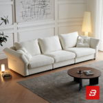 Warm elegant living room interior view of a luxury plump cushion sofa upholstered in textured off white bouclé fabric featuring deep plush back pillows and angled armrests by Bahoo Furniture UAE