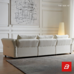 Warm elegant living room interior view of a luxury plump cushion sofa upholstered in textured off white bouclé fabric featuring deep plush back pillows and angled armrests by Bahoo Furniture UAE