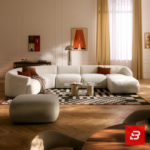 Sunlit modern luxury villa living room interior view of a luxury u-shaped modular sectional upholstered in textured off white bouclé fabric featuring a matching ottoman and rust throw pillows by Bahoo Furniture UAE