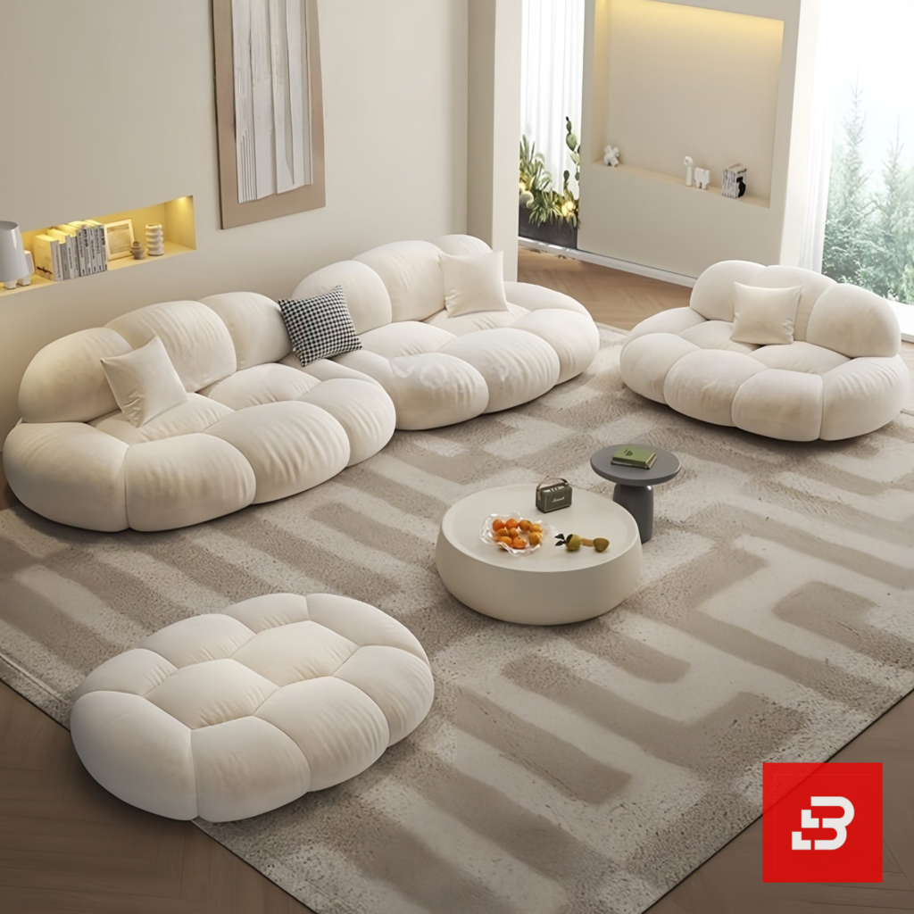Bright minimalist modern living room interior view of a luxury cloud modular sofa set upholstered in textured off white bouclé fabric featuring independent modules, an armchair, and a matching ottoman by Bahoo Furniture UAE