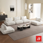 Bright elegant apartment living room interior view of a luxury independent modular lounge sofa upholstered in textured off white bouclé fabric featuring separate modular armchair elements by Bahoo Furniture UAE