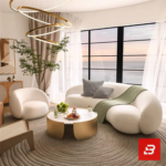 Stunning seaside modern luxury living room interior view of a luxury curved asymmetric sofa upholstered in textured off white bouclé fabric featuring a matching armchair and golden round coffee table by Bahoo Furniture UAE