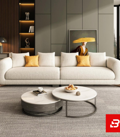 Sophisticated modern living room interior showcasing a luxury cloud sofa upholstered in textured beige bouclé fabric featuring plush modular cushioning and stylish accent pillows by Bahoo Furniture UAE