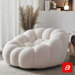 Cozy modern room interior showcasing a luxury bubble armchair upholstered in soft off white bouclé fabric featuring tufted channel cushioning and rounded contours by Bahoo Furniture UAE
