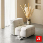 Warm minimalist living room interior showcasing a luxury modular armchair upholstered in soft off white bouclé fabric featuring tufted block cushioning and stackable books underneath by Bahoo Furniture UAE
