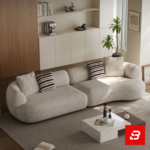 Elegant modern minimalist living room interior showcasing an asymmetric curved sofa upholstered in textured beige bouclé fabric featuring speckled details and stylish striped accent pillows by Bahoo Furniture UAE