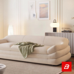 Warm sunlit modern minimalist living room interior showcasing a luxury layered sofa upholstered in textured off white bouclé fabric featuring distinctive multi-tiered horizontal cushioning and soft throw blanket by Bahoo Furniture UAE